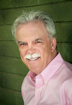 Kevin Clark Portrait in Pink Shirt Against Green Wall