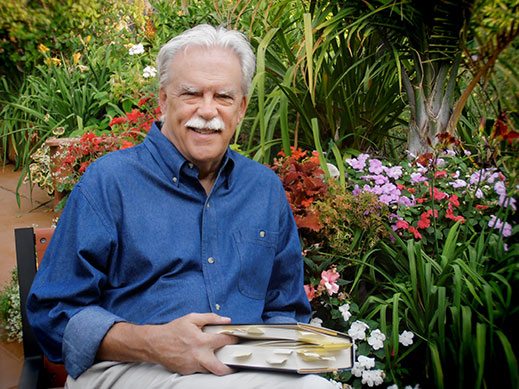 Kevin Clark Portrait in Blue Shirt with Book